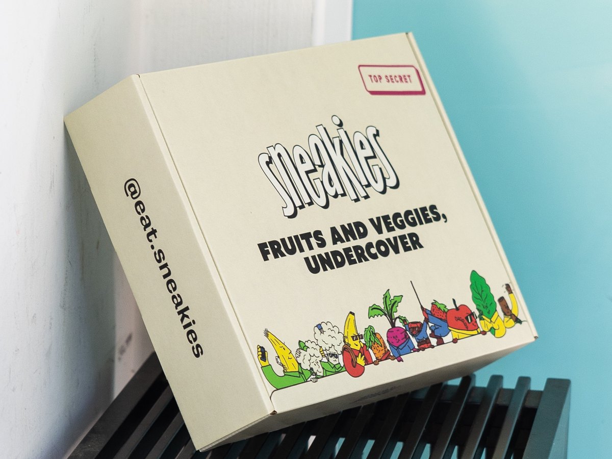 A Sneakies box delivered and waiting by a front door